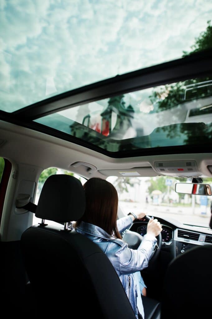 Gorgeous woman sitting inside car interior.
